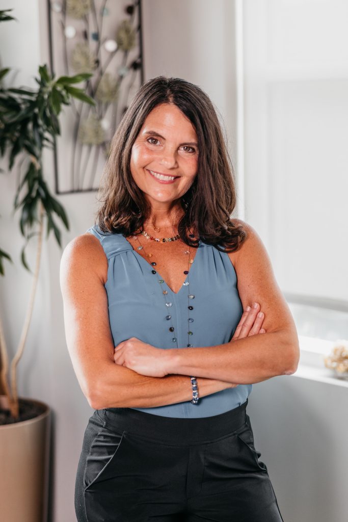 Dr. Lisa Koche standing in office with arms crossed