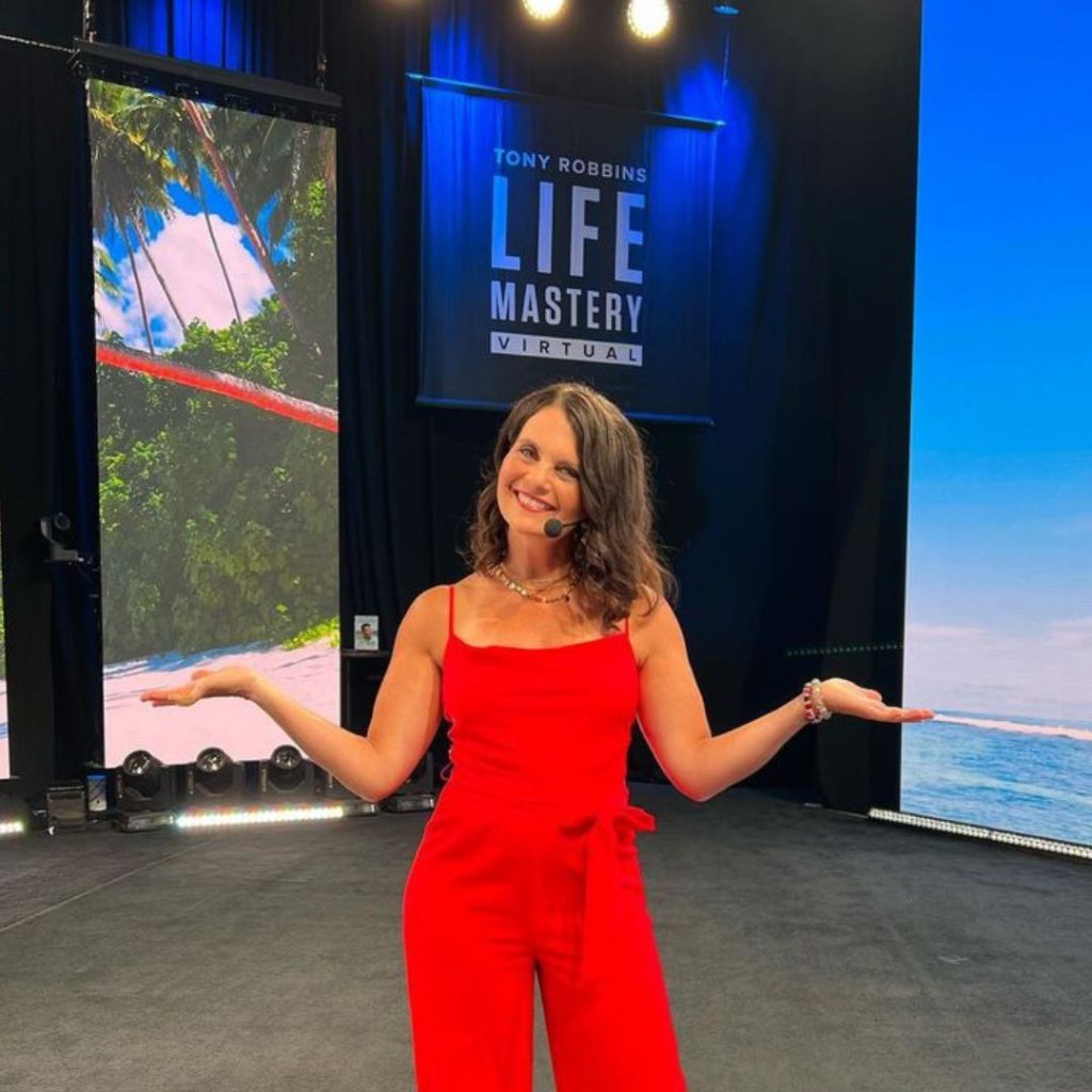 Dr. Lisa Koche speaking at a Tony Robbins life mastery summit
